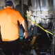 Wesley Hartzog walking through his burned out garage where it’s believed his Galaxy Note 7 started a fire (WMBF News screenshot)